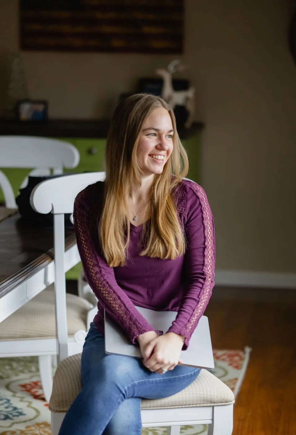 Abigail Parker, Certified Nutritional Therapy Practitioner and founder of Nourished Revival, at home with her laptop