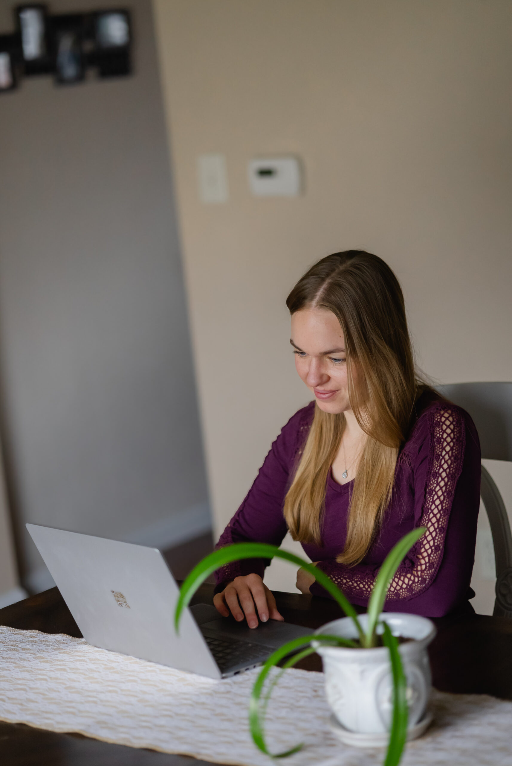 Abigail Parker, owner of Nourished Revival with her laptop, in a virtual client call